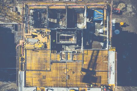 Aerial view of construcion site. People working. Top view of new apartment under construction. Picture made by drone from above.の写真素材