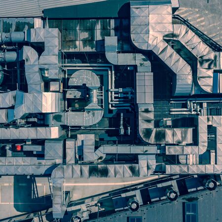 Ventilation System on the Building Roof. Rainy Weather. Industrial Air system of ventilation and Air conditioning. Aerial Shot.の写真素材