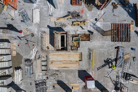 Contstruction Site from above. Aerial view of new apartment under construction. People working. Top view industrial place.の写真素材