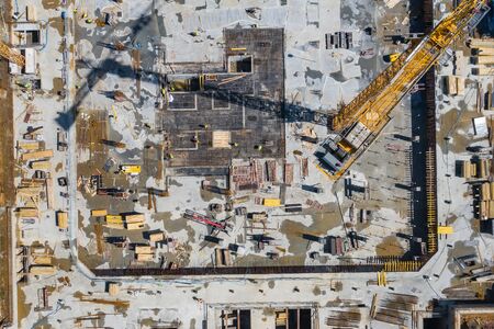 Contstruction Site from above. Aerial view of new apartment under construction. People working. Top view industrial place.の写真素材