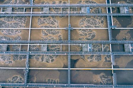 Sewage Farm Aerial View. Clarifying tanks and green grass. Top view of sewage treatment plant. Geometric background texture.の写真素材