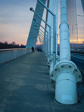 Men on the bridge in sunrise lightの写真素材