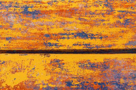 Multicolored paintings on boards. Burt wooden boat, the remains of multiple painting, boat with different colors. Different colors of paint on an old boat.の写真素材