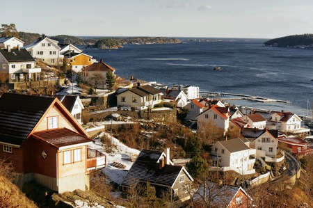 Kragero, telemark. Norway - February 2015. Colorful wooden houses on the bay. Views of the fjord and the North Sea from the top. Windy winter day.のeditorial素材