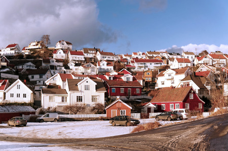 Kragero, Telemark. Norway - February 2015. Wooden and modern buildings on a rocky hill. Winter view of the neighborhood over the bay fjord.のeditorial素材