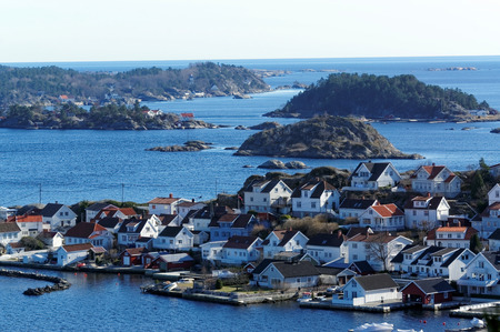 Kragero, Telemark. Norway - February 2015. View from the top shelf for small islands on the fjord. Small wooden houses letenie, cottage, traditional hytty on the islands. The shore of the fjord. Southern Norway.のeditorial素材