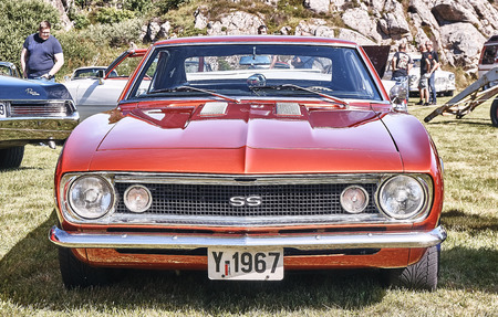 Froya island, Norway - 24 July 2016: Front of the classic Chevrolet Nova SS car in red  at cars show in norwegian Islanders Classic Car Club - Kysttreffet 2016.

Island in the Atlantic Ocean and Norwegian fjord.のeditorial素材