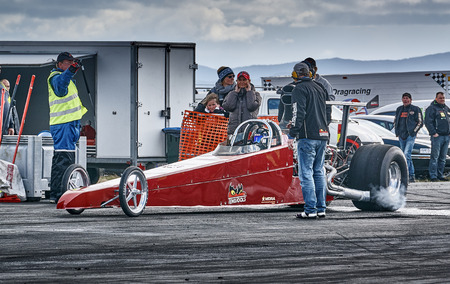 Froya, Norway, 24 June 2016: Norwegian high-skill motor sport  competitions and demonstration of fast cars drifting in Norway. Maroon racing car during the race. Cars drifting, burning out, sliding, cars driving fast. Island in the Atlantic Ocean and Norwのeditorial素材
