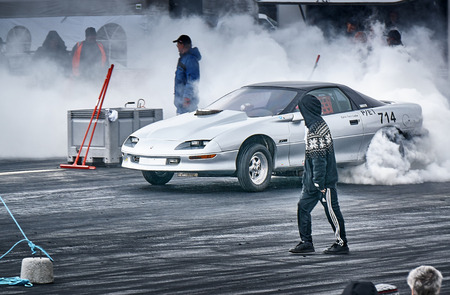 Froya, Norway, 24 June 2016:  Cars drifting, burning out, sliding, cars driving fast. Island in the Atlantic Ocean and Norwegian fjord. Norwegian high-skill motor sport  competitions and demonstration of fast cars drifting in Norway.のeditorial素材