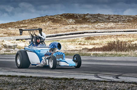 Froya, Norway, 24 June 2016: Norwegian high-skill motor sport  competitions and demonstration of fast cars drifting in Norway. White blue racing car with a driver. Cars drifting, burning out, sliding, cars driving fast. Island in the Atlantic Ocean and Noのeditorial素材