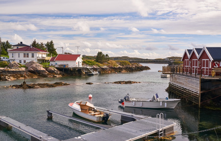 Nord Dyroy, Norway - July 31, 2016: Marina on the  fjord. Rural landscape, an old fishing village on a small island in the Norwegian Sea. Around the rocks covered with mosses and lichens. Windy day.のeditorial素材