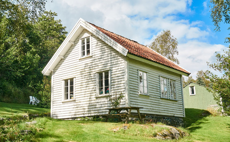 Fogn, Norway - July 17, 2015: White house on the island in summer. Norwegian fjords Bokna Fjord landscape located in Rogaland county. Around Stavanger. Small island Fogn. Windy day.のeditorial素材