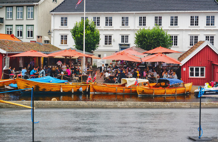 Kragero, Norway - August 9, 2014: Traditional wooden boat, boat festival. Maritime haven in the city of Norway Telemark. Colorful flags. Norwegian summer.のeditorial素材
