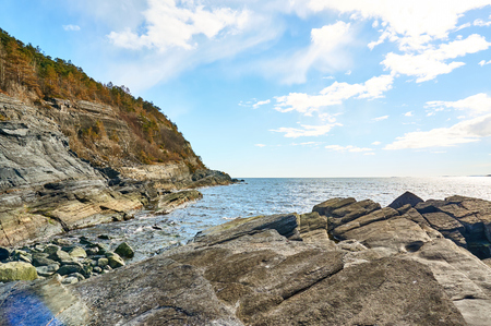 Bamble, Norway -  April 3, 2015: Rocks and boulders on the beach. Exhibits a high grade gneiss terrane characterized by metasomatism.  Lying at the southern tip of the Kongsberg-Bamble geological formation. Traditional region of Grenlandのeditorial素材