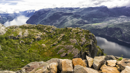 Preikestolen, Norway - July 27, 2016: Lysefjord  light fjord lightly coloured granite rocks along its sides. Extraordinary scenery of the Lysefjorden itself.  Preikestolen cliff overlooking the fjord.のeditorial素材