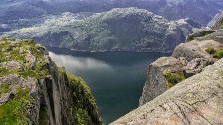 Preikestolen, Norway - July 27, 2016: Lysefjord  light fjord lightly coloured granite rocks along its sides. Extraordinary scenery of the Lysefjorden itself.  Preikestolen cliff overlooking the fjord.のeditorial素材