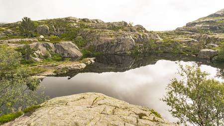 Preikestolen, Norway - July 27, 2016: Lysefjord  light fjord lightly coloured granite rocks along its sides. Extraordinary scenery of the Lysefjorden itself.  Preikestolen cliff overlooking the fjord.のeditorial素材