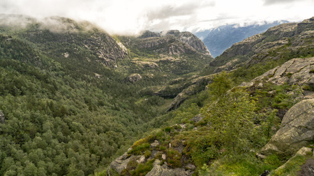 Preikestolen, Norway - July 27, 2016: Lysefjord  light fjord lightly coloured granite rocks along its sides. Extraordinary scenery of the Lysefjorden itself.  Preikestolen cliff overlooking the fjord.のeditorial素材