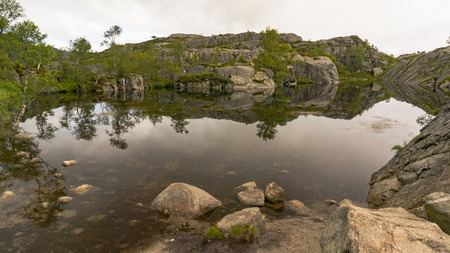 Preikestolen, Norway - July 27, 2016: Lysefjord  light fjord lightly coloured granite rocks along its sides. Extraordinary scenery of the Lysefjorden itself.  Preikestolen cliff overlooking the fjord.のeditorial素材