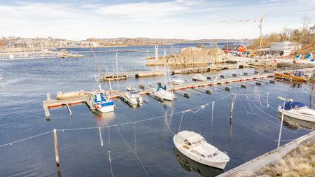 Kristiansand, Norway - June 4, 2015:  Aerial view on boats, yacht and colorful buildings, red, canvas and orange wooden buildings and restaurants on the harbor. Gulf of Kristiansand.のeditorial素材