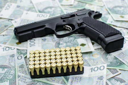 Gun and ammunition on money