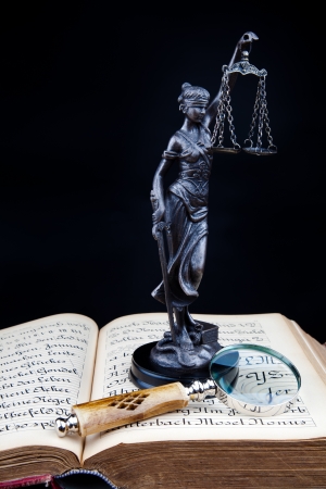 old book, lady of justice and magnifying glassの写真素材