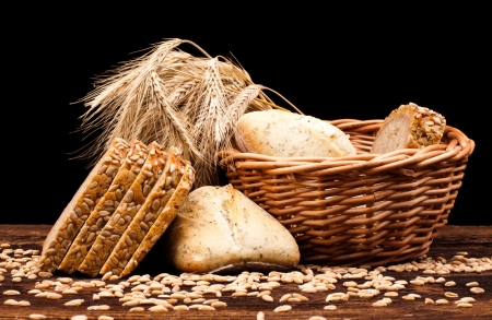assortment of baked bread on wood table and black backgroundの写真素材