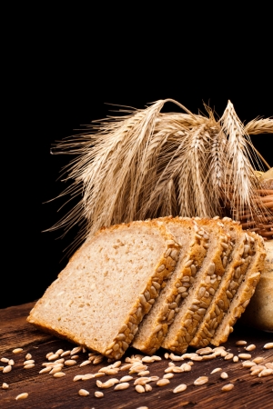 assortment of baked bread on wood table and black backgroundの写真素材