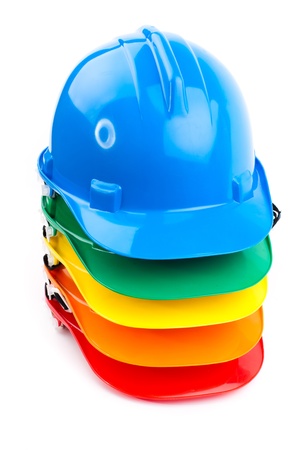 pile of colorful builder safety hardhats の写真素材