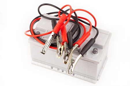 Car battery and jumper cables isolated on white