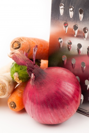 vegetables and grater isolated on whiteの写真素材