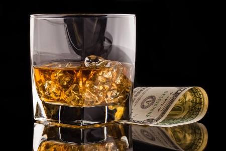 whisky  money and glass with iceの写真素材