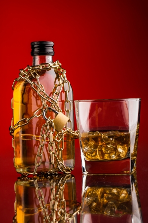 whisky bottle chain and glass with iceの写真素材