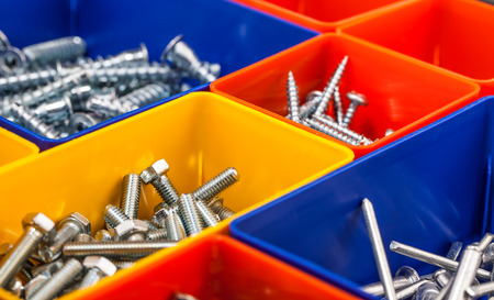 screws in colorful boxの写真素材