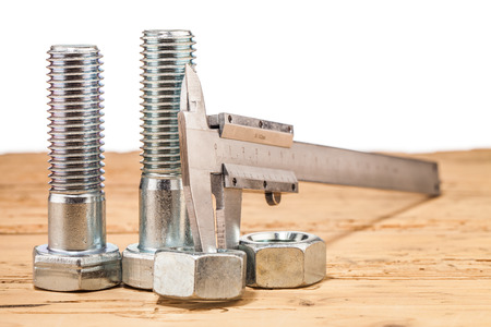 screws on wooden tableの写真素材