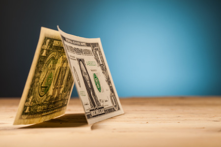 dollar money closeup on wooden table and blue background