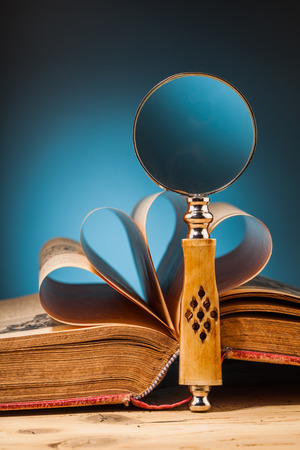 old book on wooden table and blue backgroundの写真素材