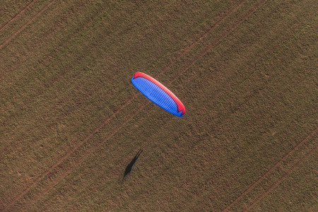 aerial view of paramotor over harvest fields in Polandの写真素材