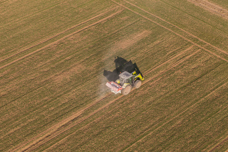 aerial view of harvest fields with tractor in Poland