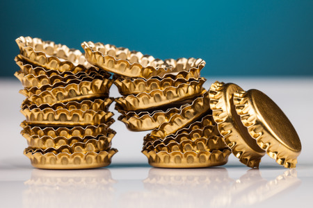 golden bottle caps on tableの写真素材