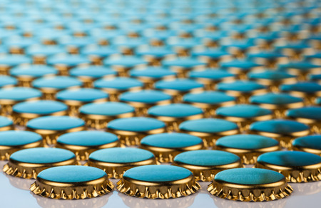 golden bottle caps on tableの写真素材