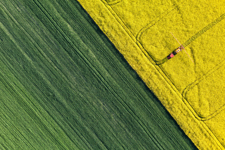 aerial view of harvest fields with tractor in Poland aerial view of harvest fields with tractor in Poland