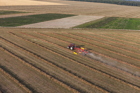 aerial view of harvest fields with tractor in Poland