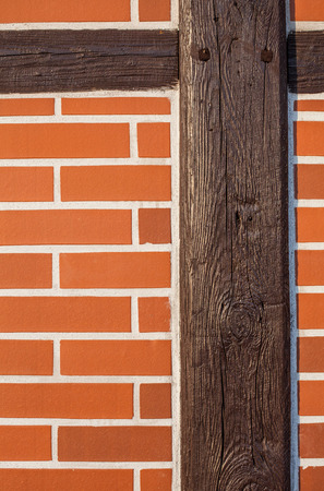Background of renovated brick wall with old wooden postの写真素材