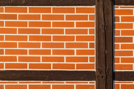 Background of renovated brick wall with old wooden post