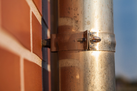 gutter pipe and brick wall