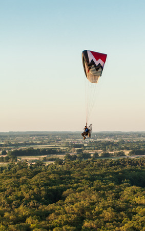aerial view of paramotor flying over the fields in summerの写真素材
