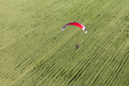 aerial view of paramotor flying over the fields in summerの写真素材