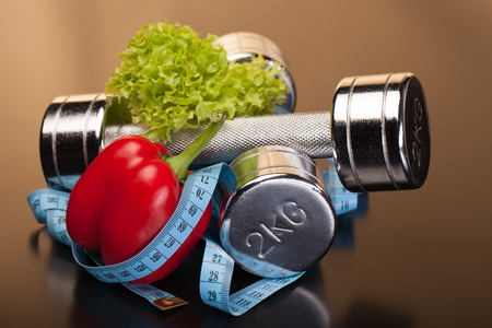 fitness equipment and healthy food on black surfaceの写真素材