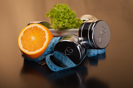 fitness equipment and healthy food on black surfaceの写真素材